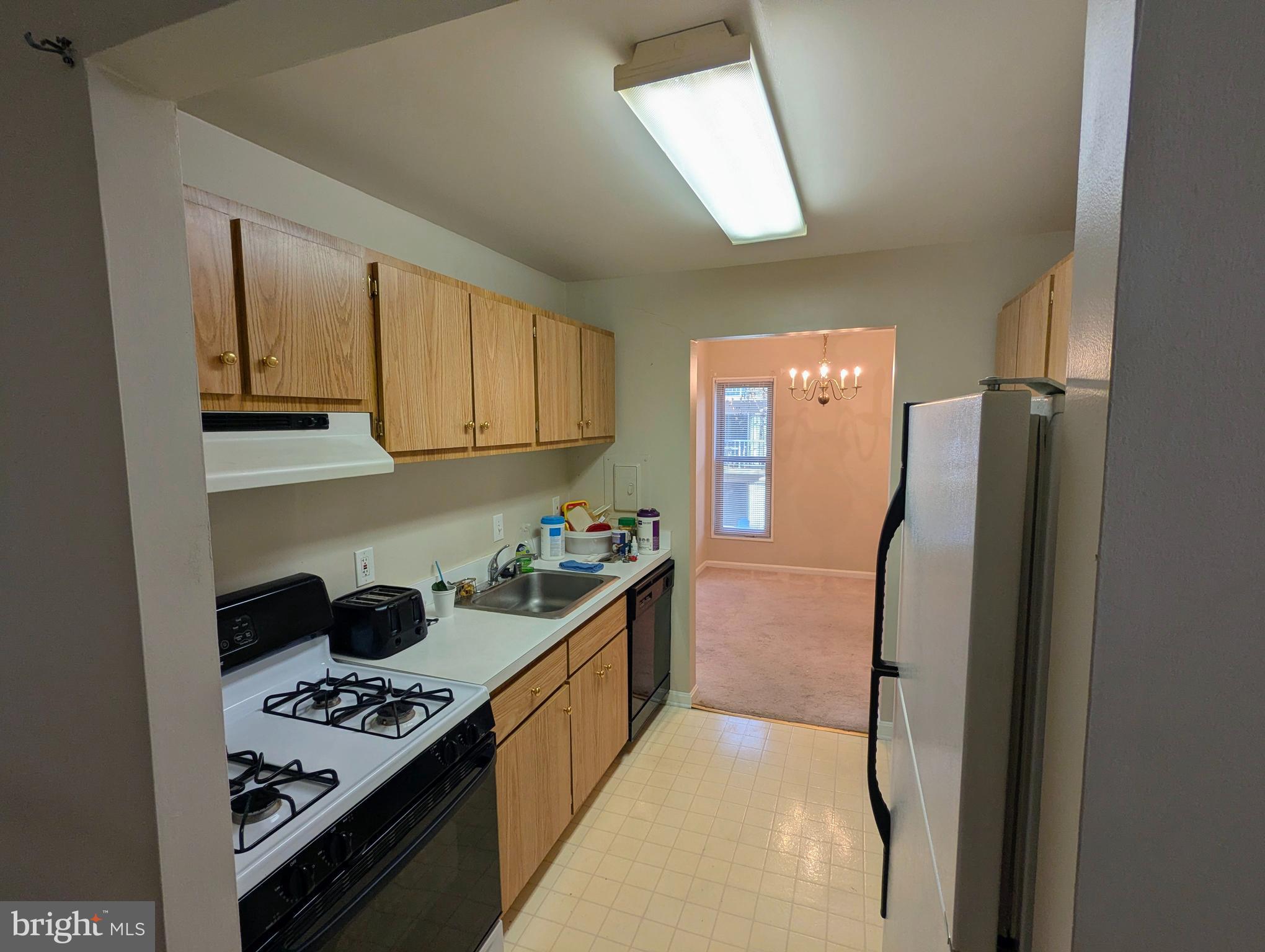 15 Canterbury Square, Unit 202 Alexandria, VA 22304 - Photo 8 of 14 a kitchen with stainless steel appliances granite countertop a stove a refrigerator and a sink