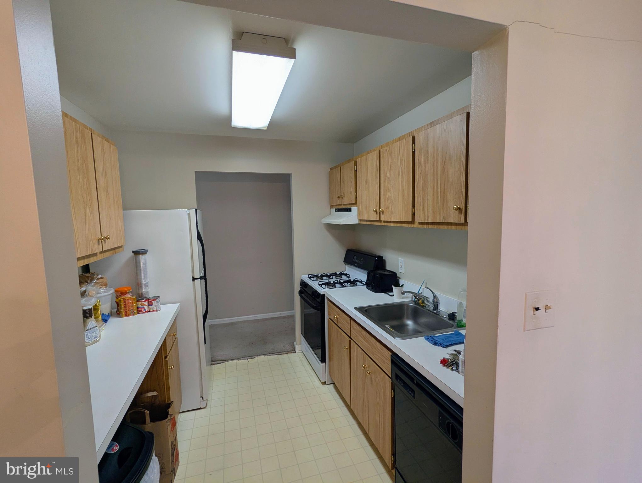 15 Canterbury Square, Unit 202 Alexandria, VA 22304 - Photo 10 of 14 a kitchen with granite countertop cabinets and refrigerator