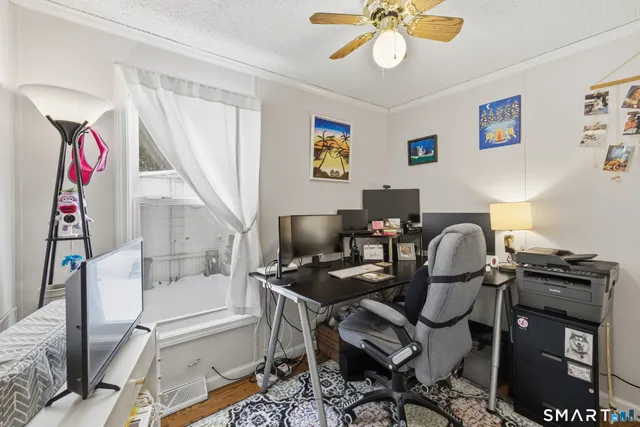 a work room with furniture and wooden floor