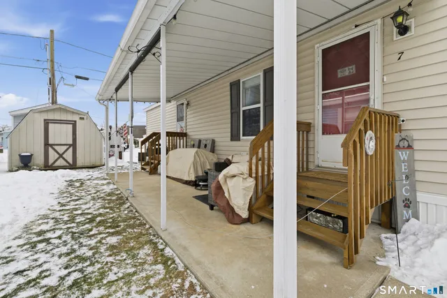 a view of a patio with a table and chairs