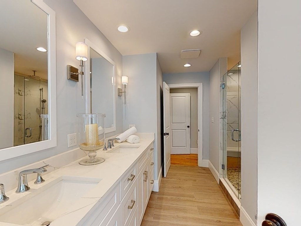 148 Main Street Waltham, MA 02453 - Photo 25 of 42 a bathroom with a double vanity sink and a mirror