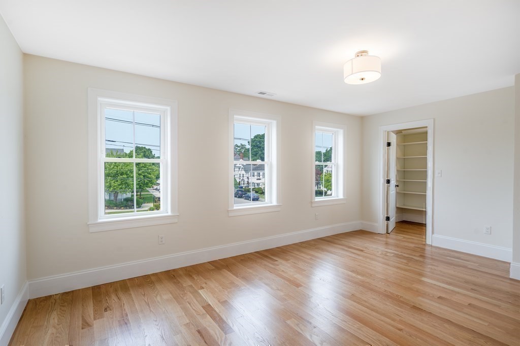 148 Main Street Waltham, MA 02453 - Photo 26 of 42 an empty room with wooden floor and windows