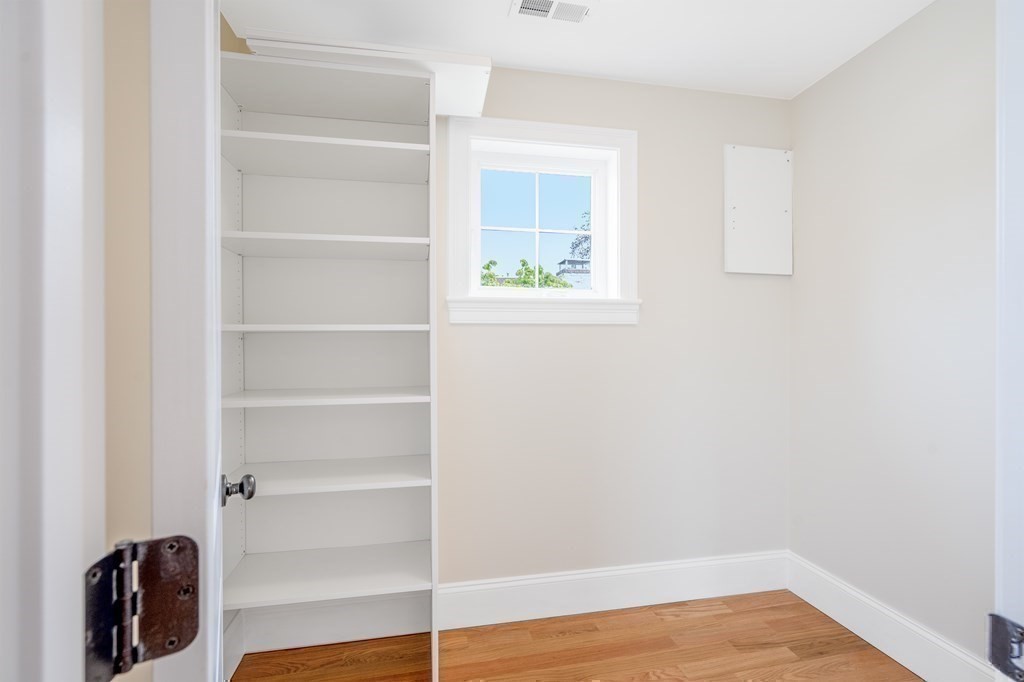 148 Main Street Waltham, MA 02453 - Photo 35 of 42 a view of walk in closet with empty racks