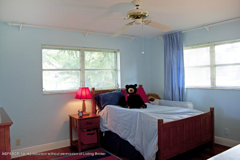 1416 Lands End Road Lantana, FL 33462 - Photo 13 of 21 a bed sitting in a bedroom next to a window