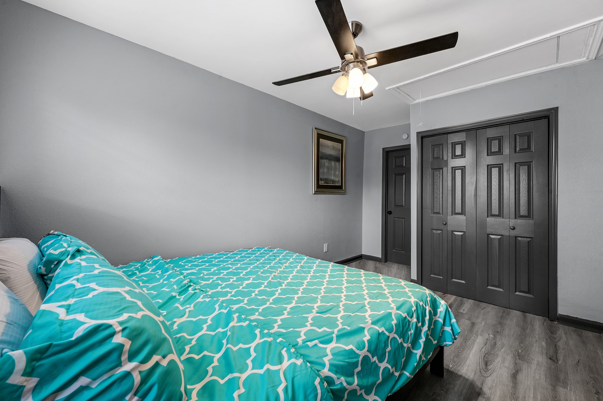 4406 Edison Street Houston, TX 77009 - Photo 12 of 24 a bedroom with a bed and a chandelier