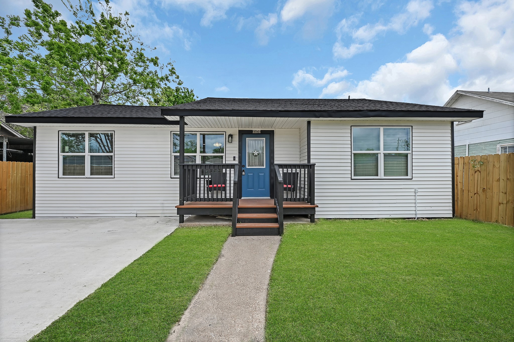 4406 Edison Street Houston, TX 77009 - Photo 2 of 24 a view of a house with a small yard and a large tree