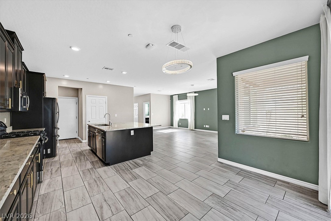 1106 Langston Ranch Avenue Henderson, NV 89002 - Photo 10 of 36 An open concept design seamlessly blends the well-equipped kitchen with a spacious living area.