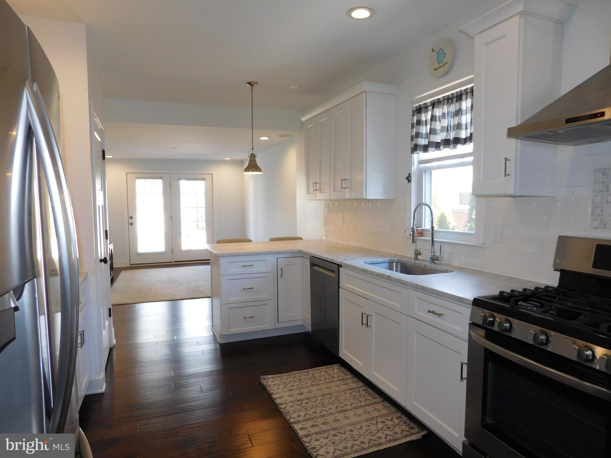 234 Crafton Avenue Pitman, NJ 08071 - Photo 18 of 61 a kitchen with granite countertop a stove a sink dishwasher and a refrigerator