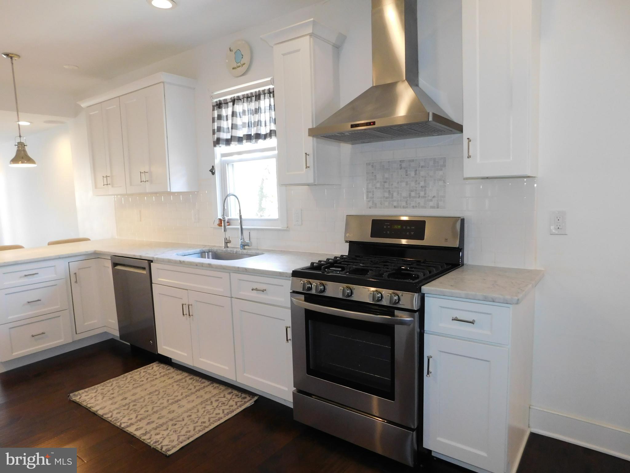 234 Crafton Avenue Pitman, NJ 08071 - Photo 19 of 61 a kitchen with a stove oven and white cabinets