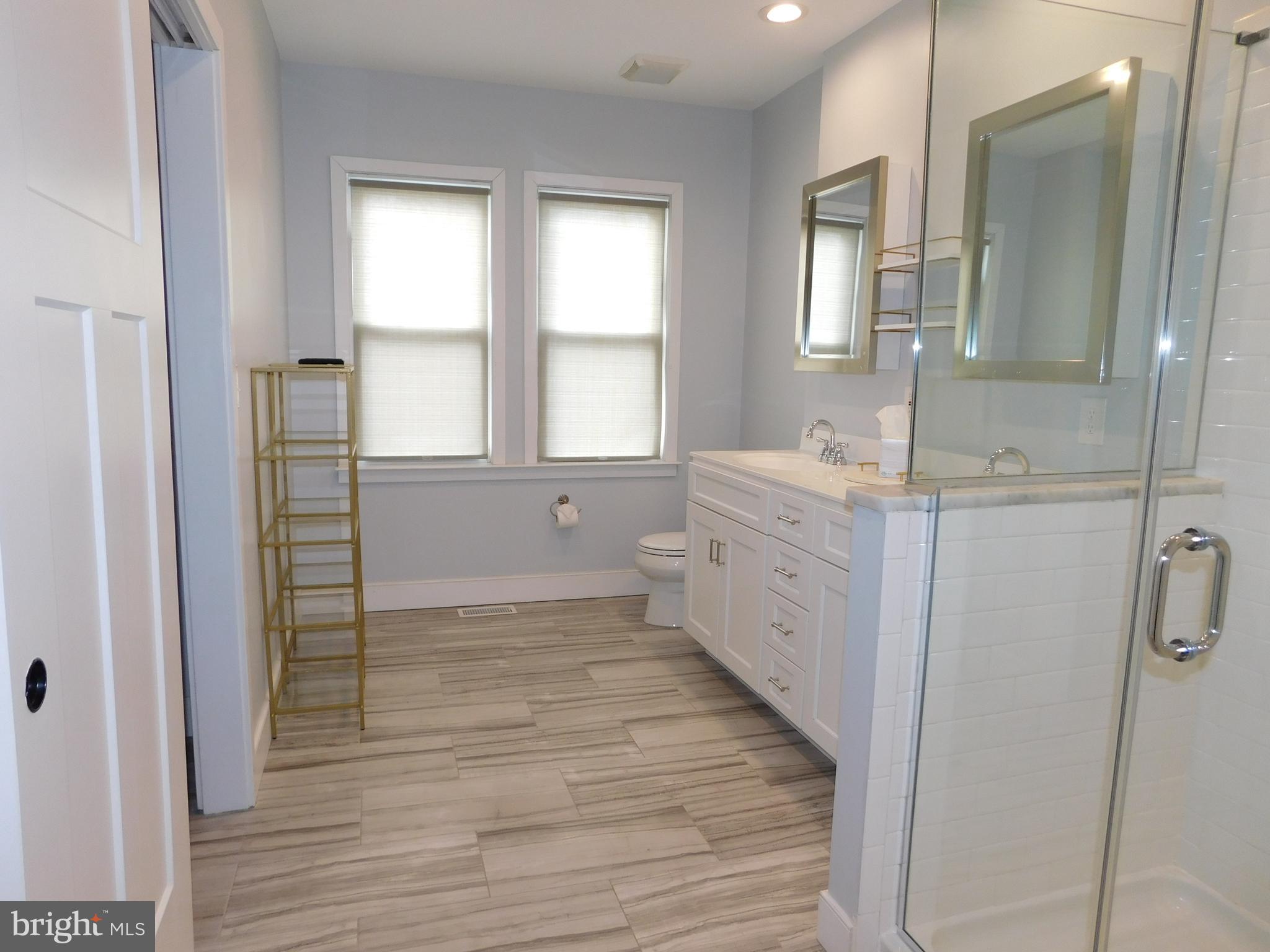 234 Crafton Avenue Pitman, NJ 08071 - Photo 29 of 61 a bathroom with a double vanity sink a mirror and a bathtub