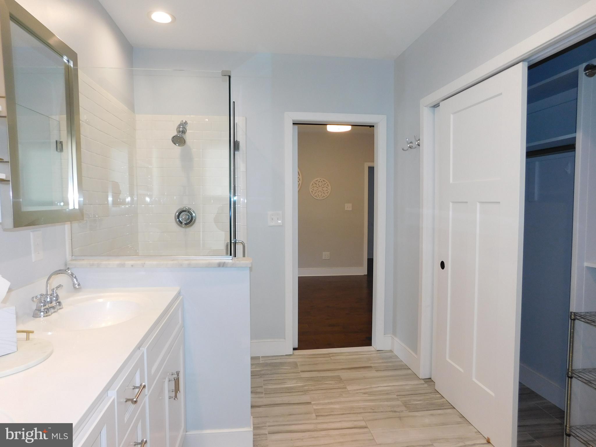234 Crafton Avenue Pitman, NJ 08071 - Photo 30 of 61 a spacious bathroom with a granite countertop sink a mirror and a shower