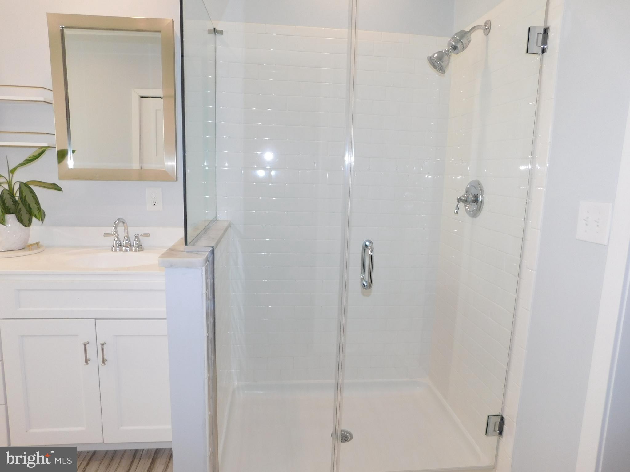 234 Crafton Avenue Pitman, NJ 08071 - Photo 31 of 61 a bathroom with a shower sink vanity and a mirror