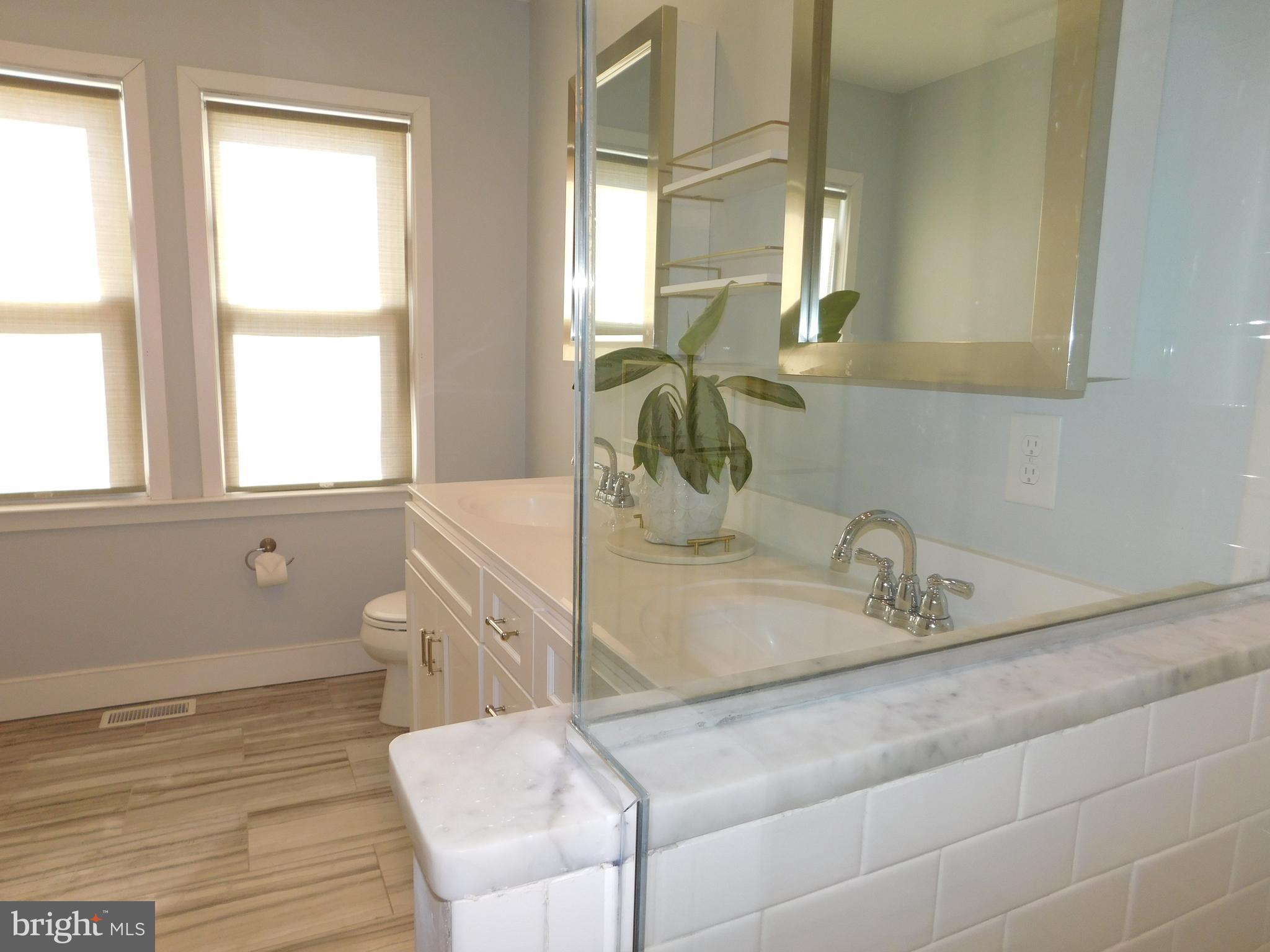 234 Crafton Avenue Pitman, NJ 08071 - Photo 32 of 61 a bathroom with a sink a toilet and a window