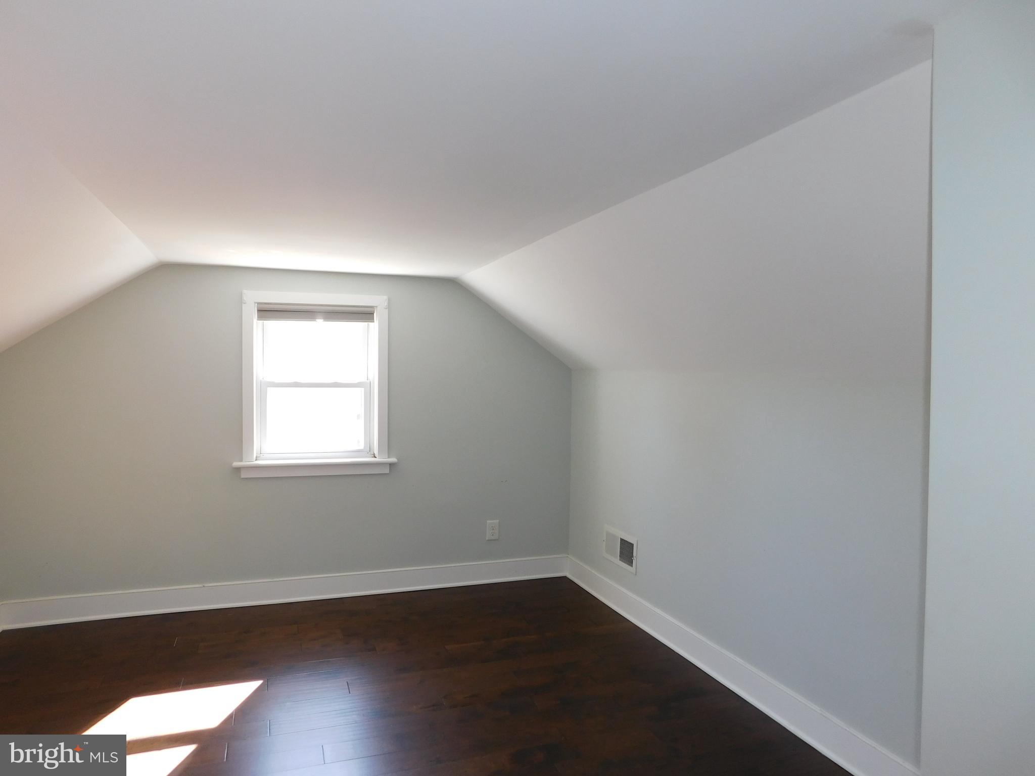 234 Crafton Avenue Pitman, NJ 08071 - Photo 37 of 61 an empty room with wooden floor and windows