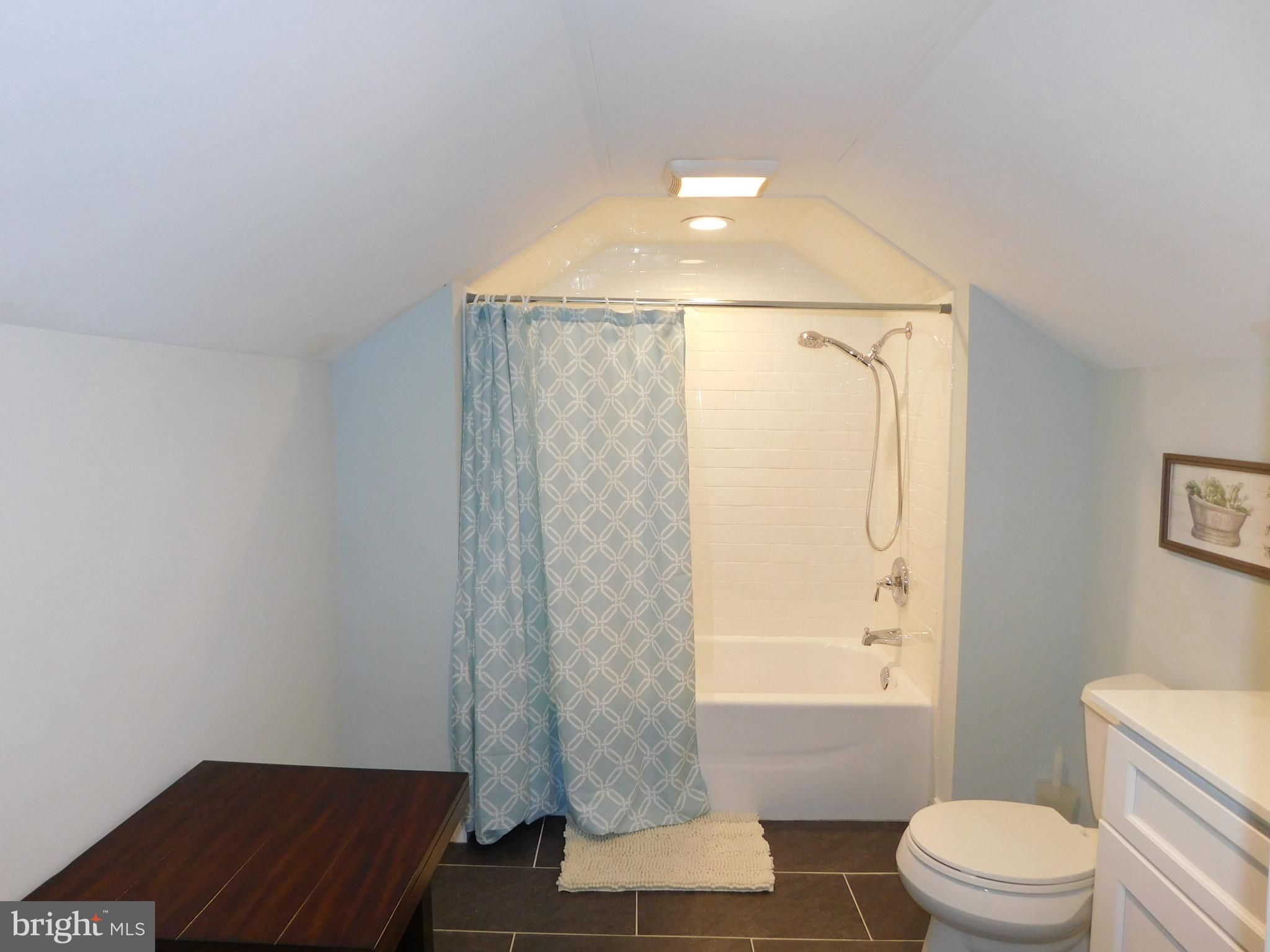 234 Crafton Avenue Pitman, NJ 08071 - Photo 41 of 61 a bathroom with a toilet and a shower curtain