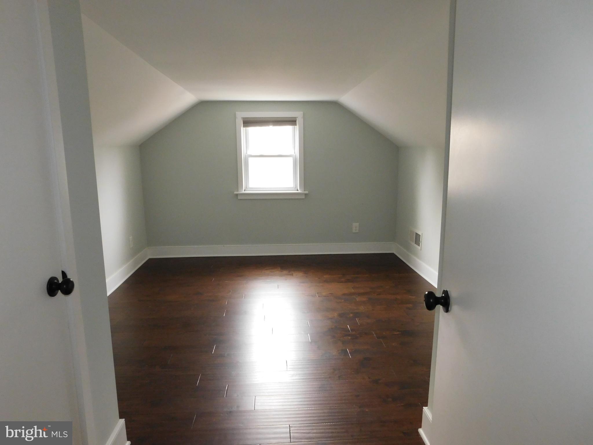 234 Crafton Avenue Pitman, NJ 08071 - Photo 42 of 61 an empty room with wooden floor and windows