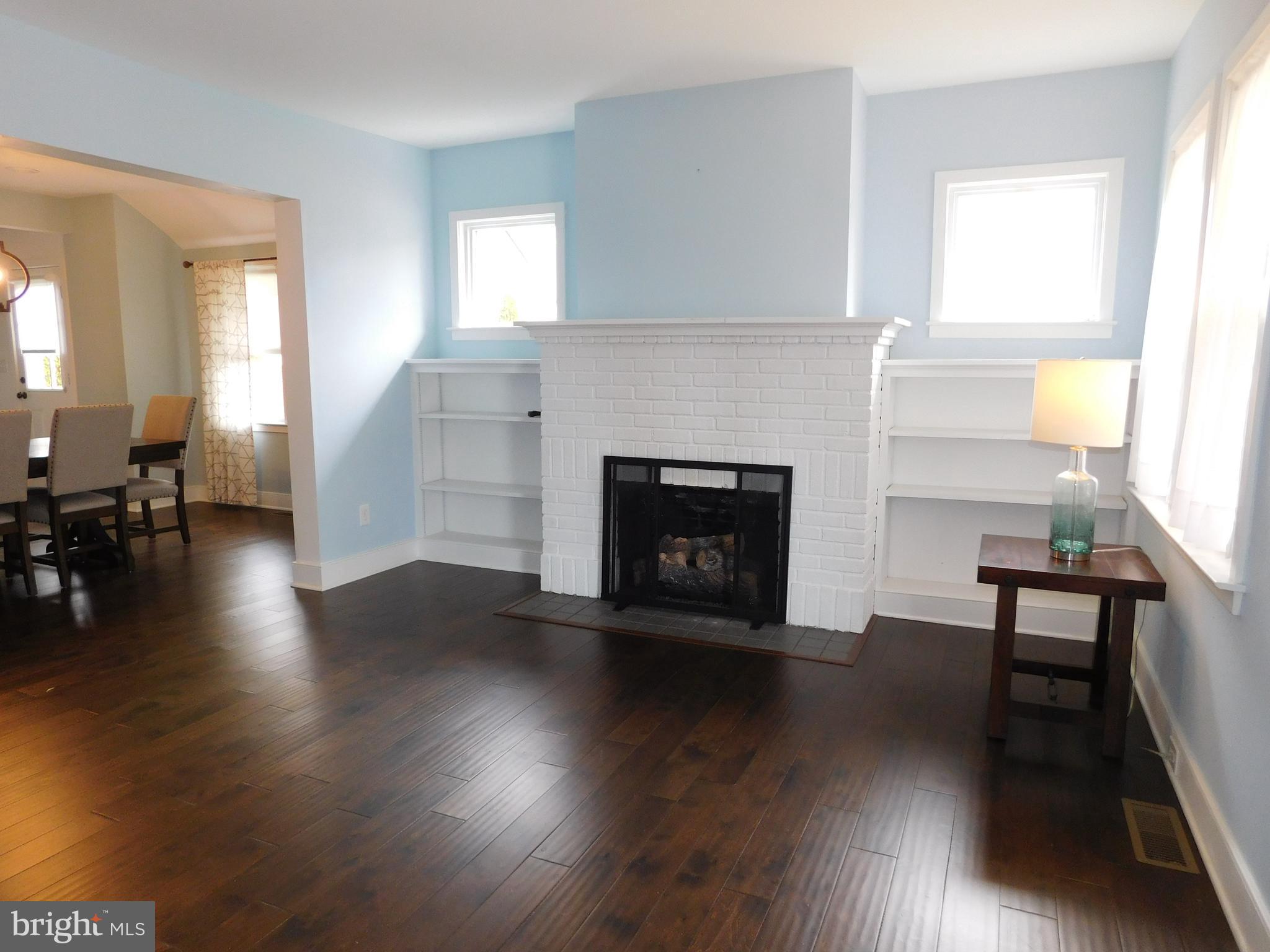 234 Crafton Avenue Pitman, NJ 08071 - Photo 10 of 61 a view of a livingroom with furniture a fireplace and wooden floor
