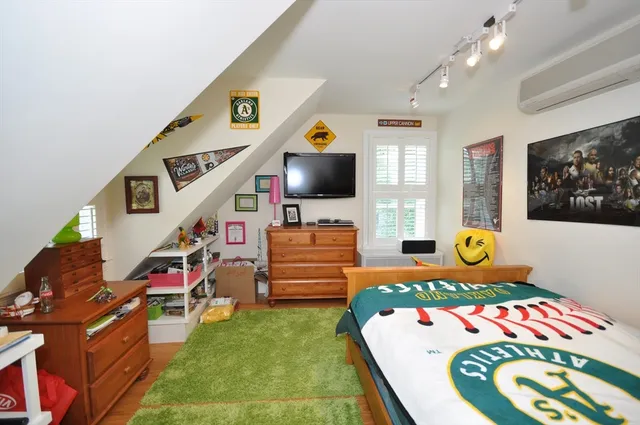 a bedroom with furniture and a flat screen tv