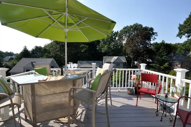 a view of an outdoor sitting area with furniture and umbrella