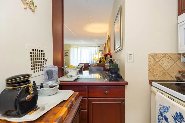 a dining room with furniture a chandelier and wooden floor
