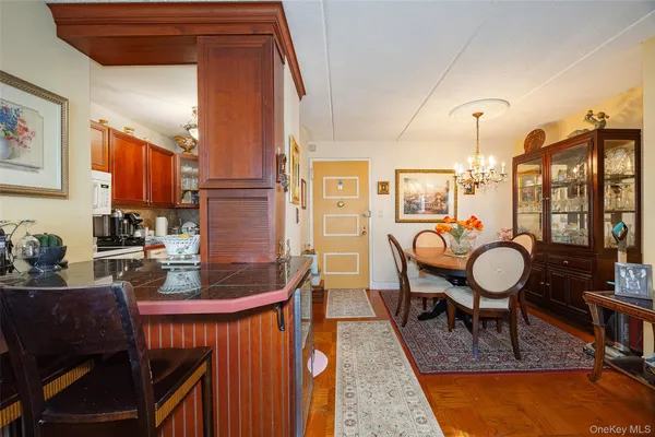 a dining room with furniture and chandelier