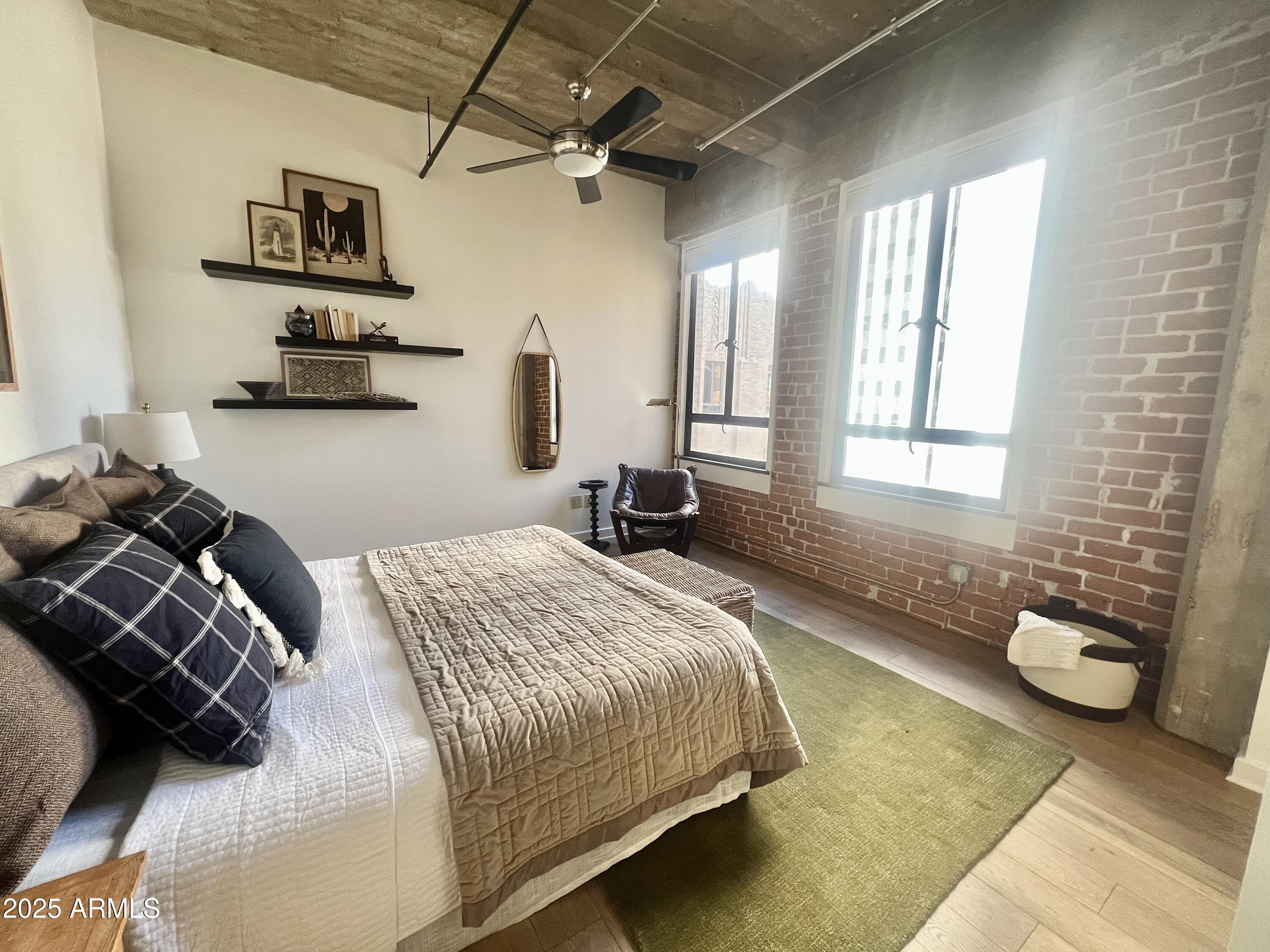 114 West Adams Street, Unit 1007 Phoenix, AZ 85003 - Photo 14 of 51 a bedroom with a bed and a window