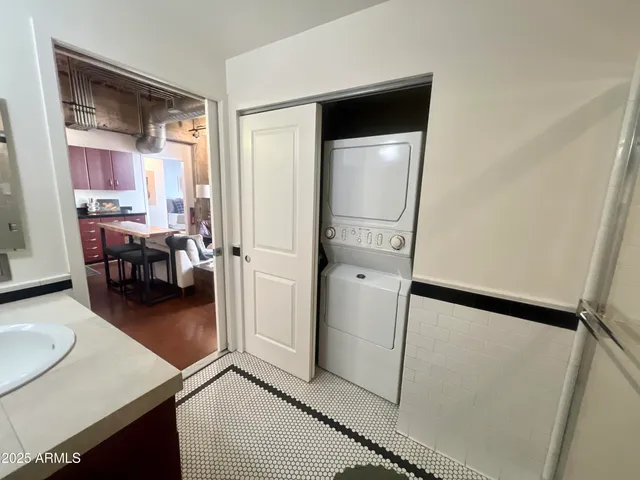 a bathroom with a double vanity sink a toilet a shower and a mirror