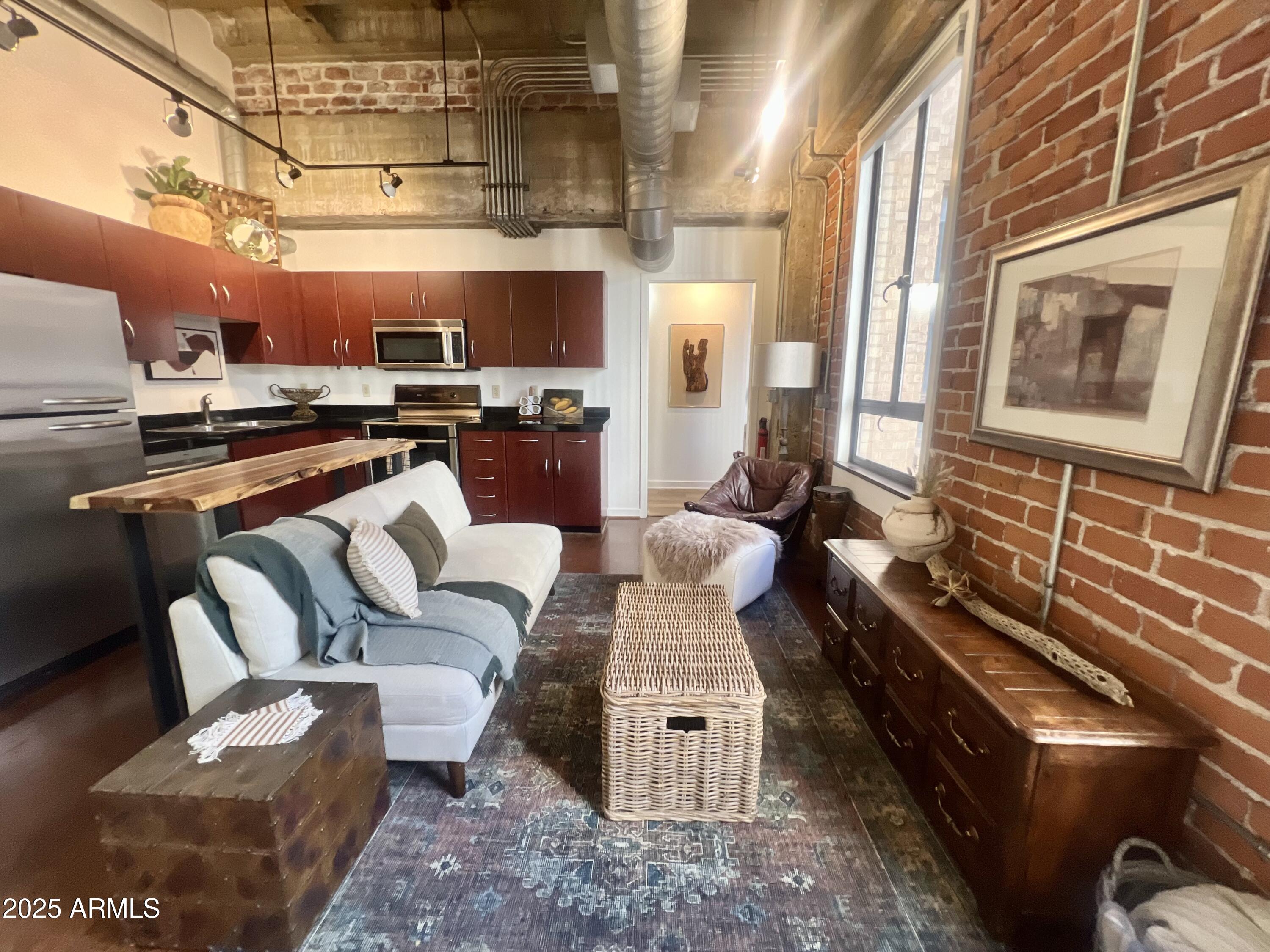 114 West Adams Street, Unit 1007 Phoenix, AZ 85003 - Photo 5 of 51 a living room with furniture and a chandelier