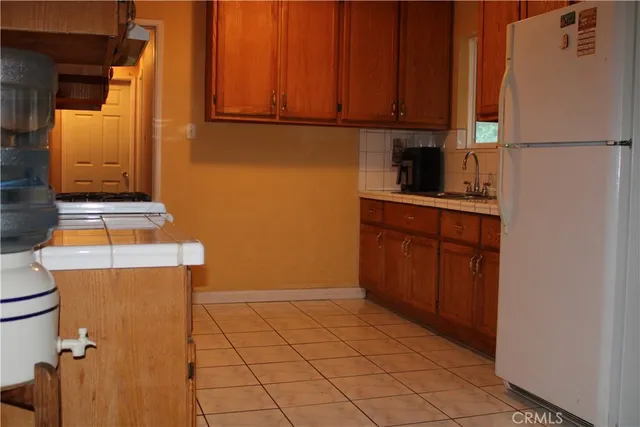a kitchen with a refrigerator and cabinets