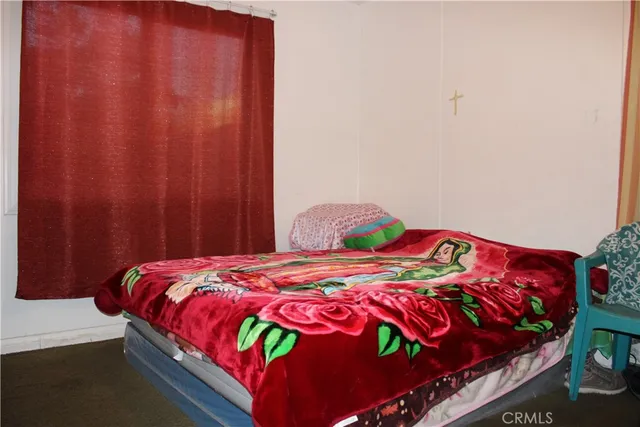 a bedroom with a bed and a table