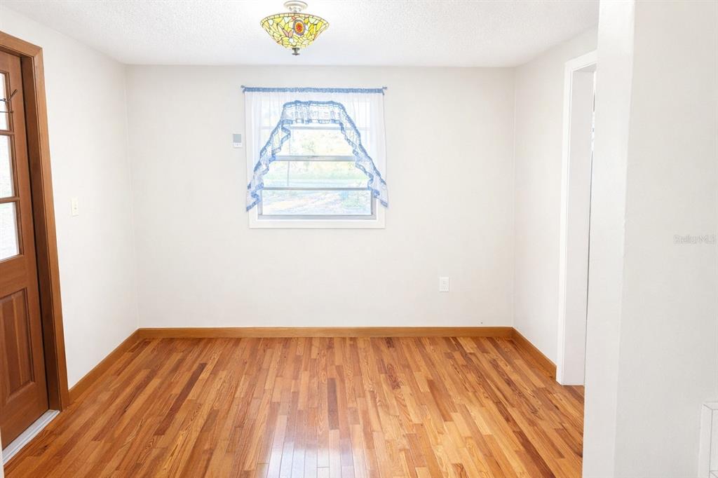 10019 Curley Road San Antonio, FL 33576 - Photo 4 of 10 a view of room with wooden floor and fan