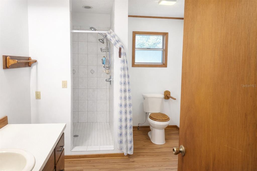 10019 Curley Road San Antonio, FL 33576 - Photo 7 of 10 a bathroom with a toilet and a shower