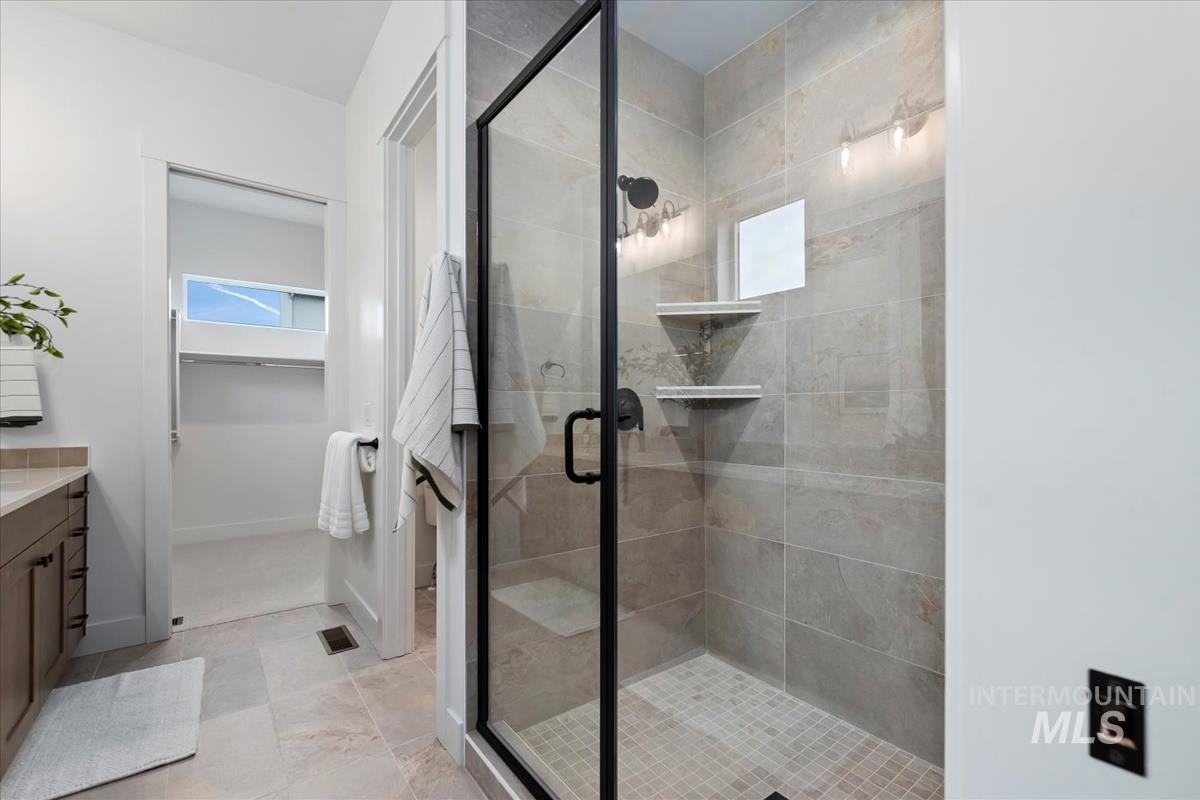 735 South Calhoun Lane Star, ID 83669 - Photo 24 of 47 Full bath with vanity, a walk in closet, and a stall shower