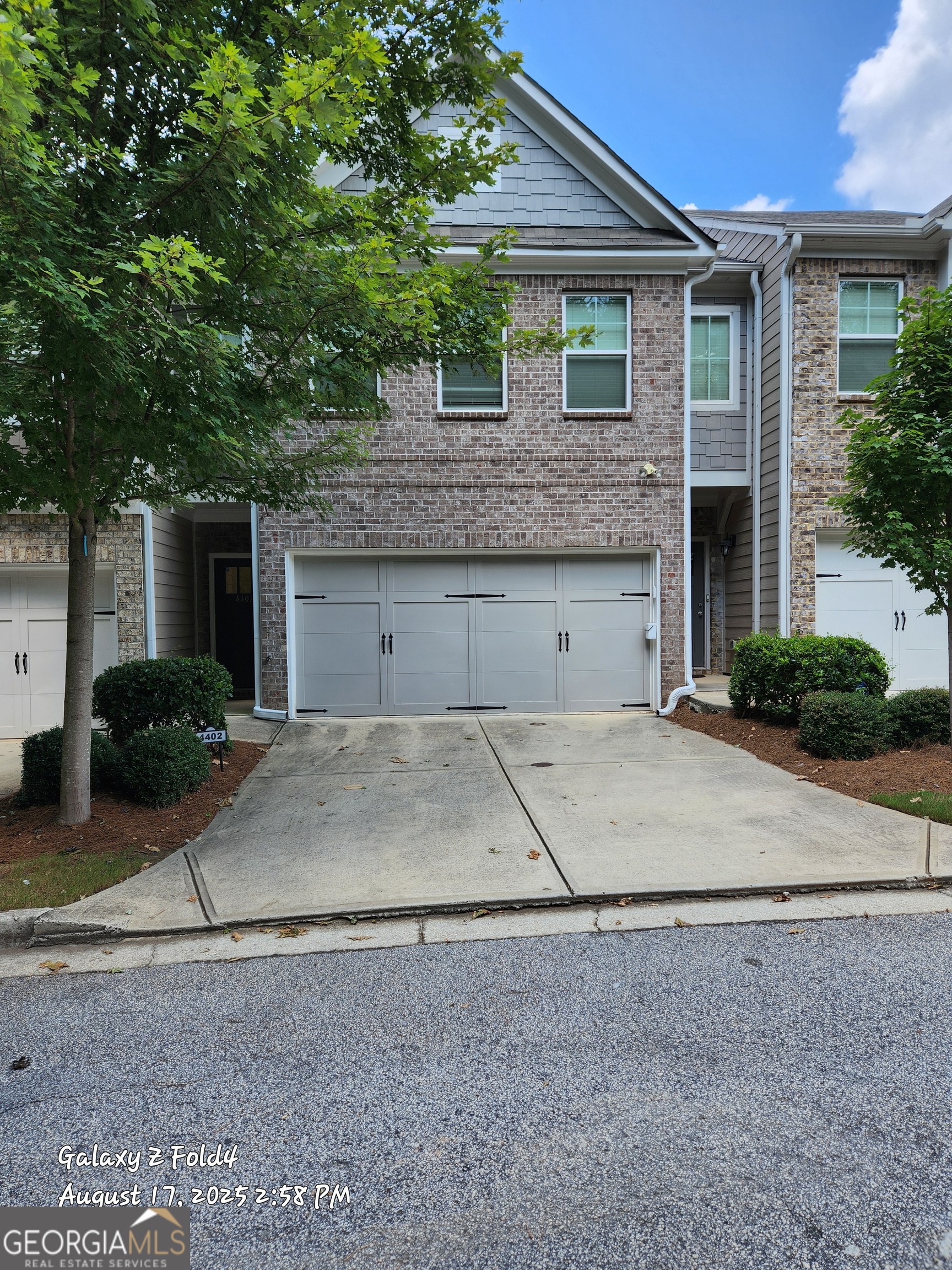 4402 Newfangle Road Stone Mountain, GA 30083 - Photo 1 of 1 a view of a house with a yard and large tree