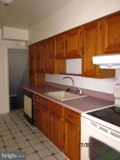 2033 Ormand Road Dundalk, MD 21222 - Photo 3 of 11 a kitchen with stainless steel appliances a sink stove and cabinets