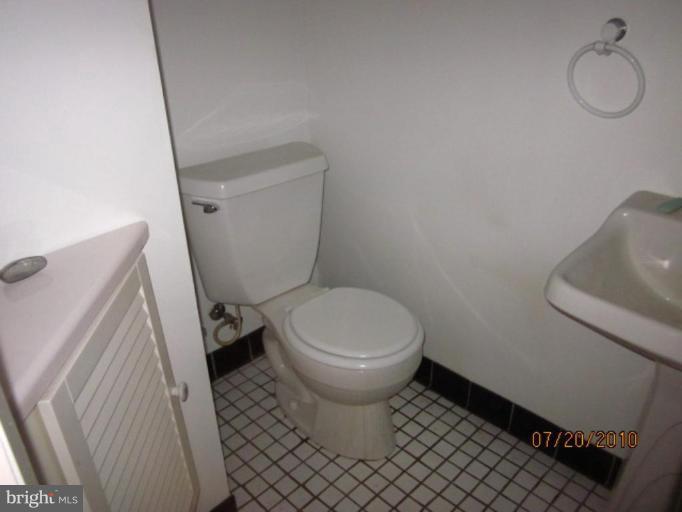 2033 Ormand Road Dundalk, MD 21222 - Photo 4 of 11 a white toilet sitting next to a white sink and vanity