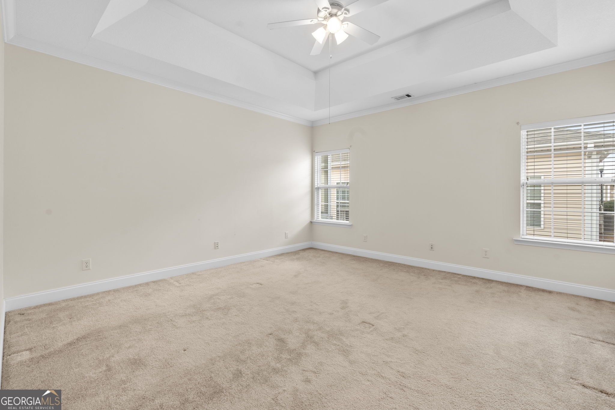 310 Pebble Beach Drive Perry, GA 31069 - Photo 18 of 42 en empty room with windows and chandelier fan