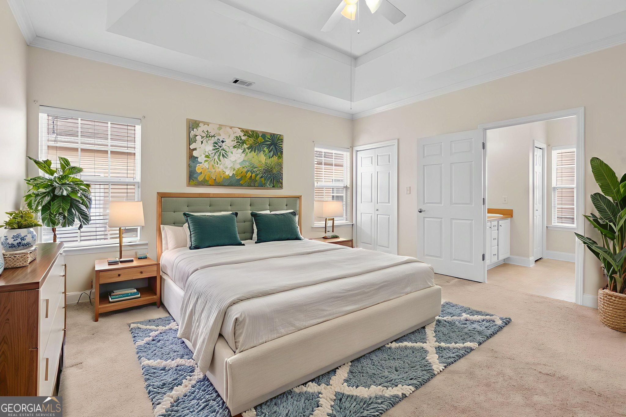 310 Pebble Beach Drive Perry, GA 31069 - Photo 22 of 42 a bedroom with a large bed and a potted plant