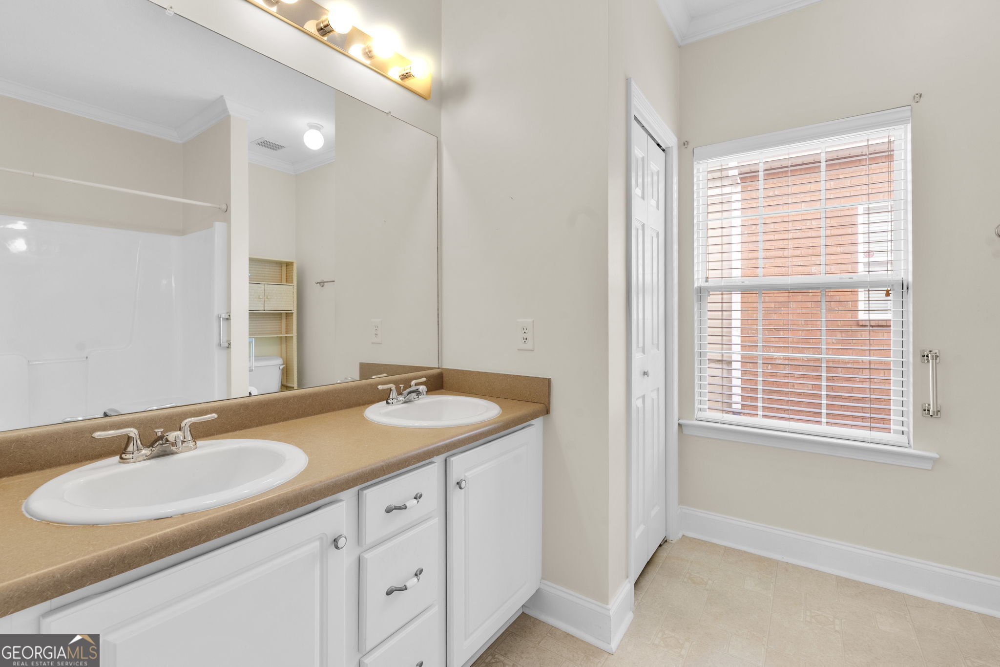 310 Pebble Beach Drive Perry, GA 31069 - Photo 23 of 42 a bathroom with a sink double vanity and a window