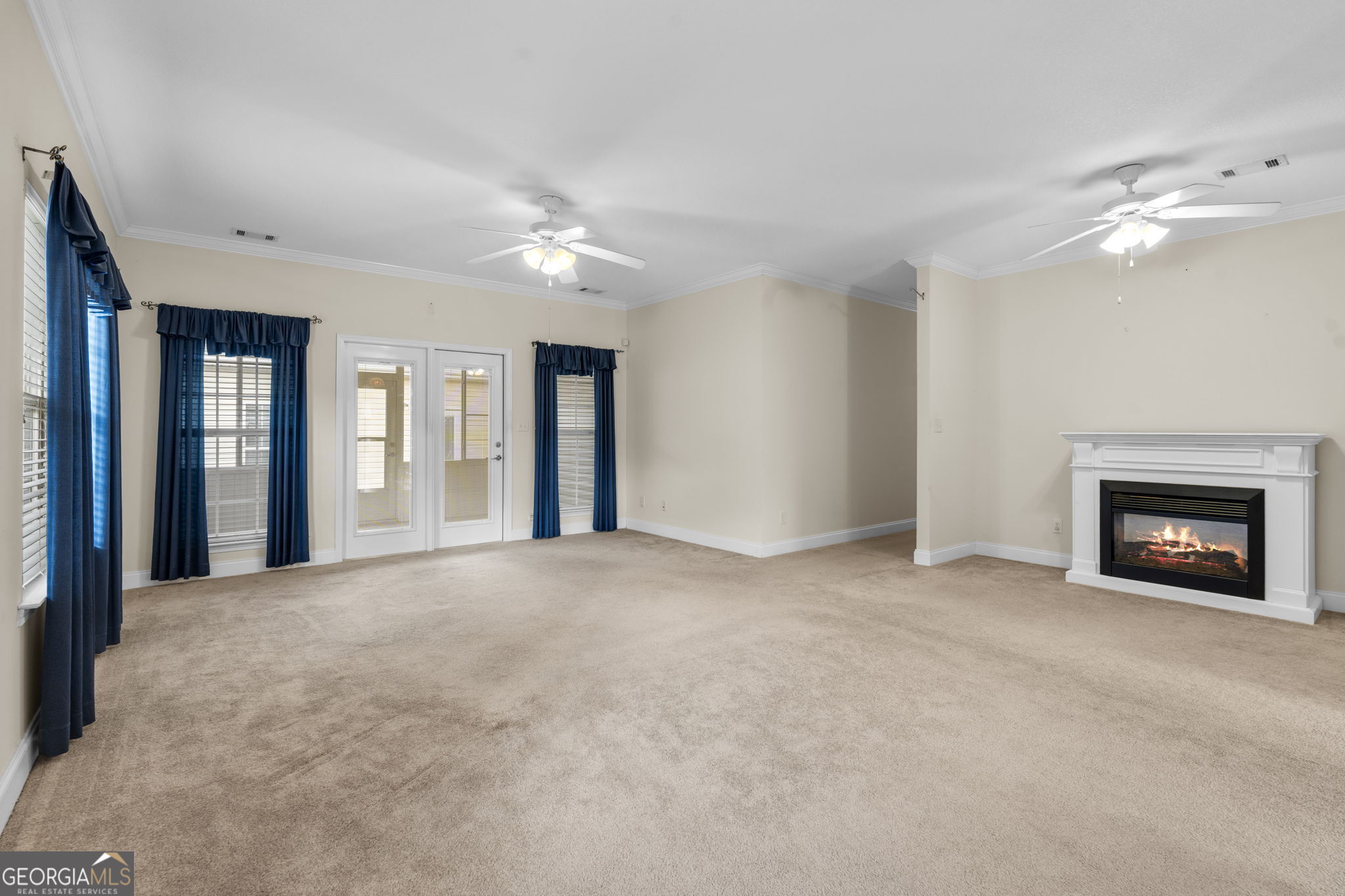 310 Pebble Beach Drive Perry, GA 31069 - Photo 28 of 42 a view of an empty room with a fireplace and a window