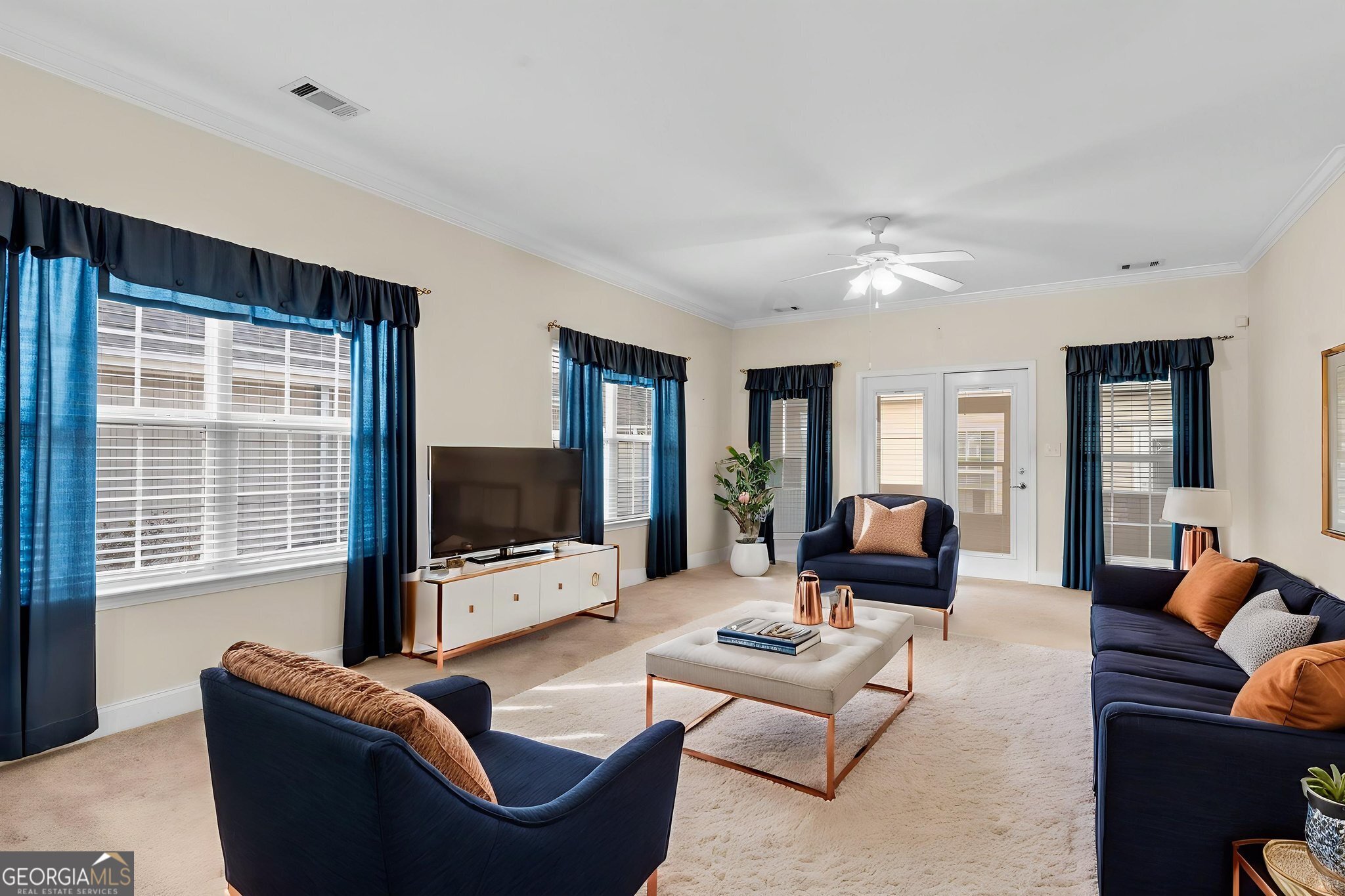 310 Pebble Beach Drive Perry, GA 31069 - Photo 31 of 42 a living room with furniture and a flat screen tv