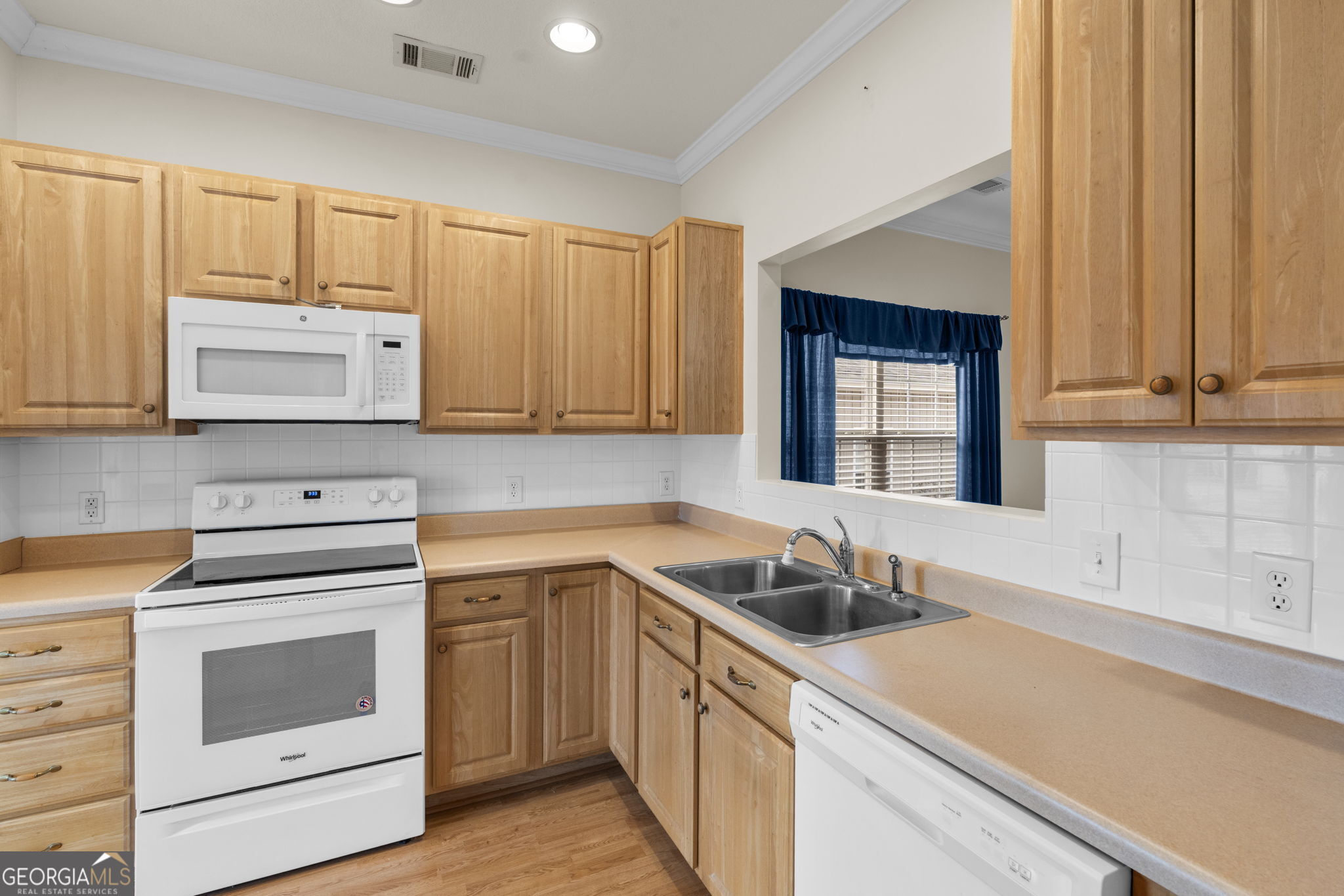 310 Pebble Beach Drive Perry, GA 31069 - Photo 5 of 42 a kitchen with stainless steel appliances granite countertop white cabinets a sink and dishwasher next to a window