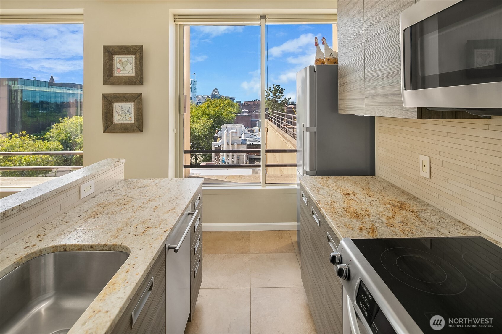 100 1st Avenue South, Unit 8 Seattle, WA 98104 - Photo 13 of 29 a kitchen with granite countertop a sink and a stove