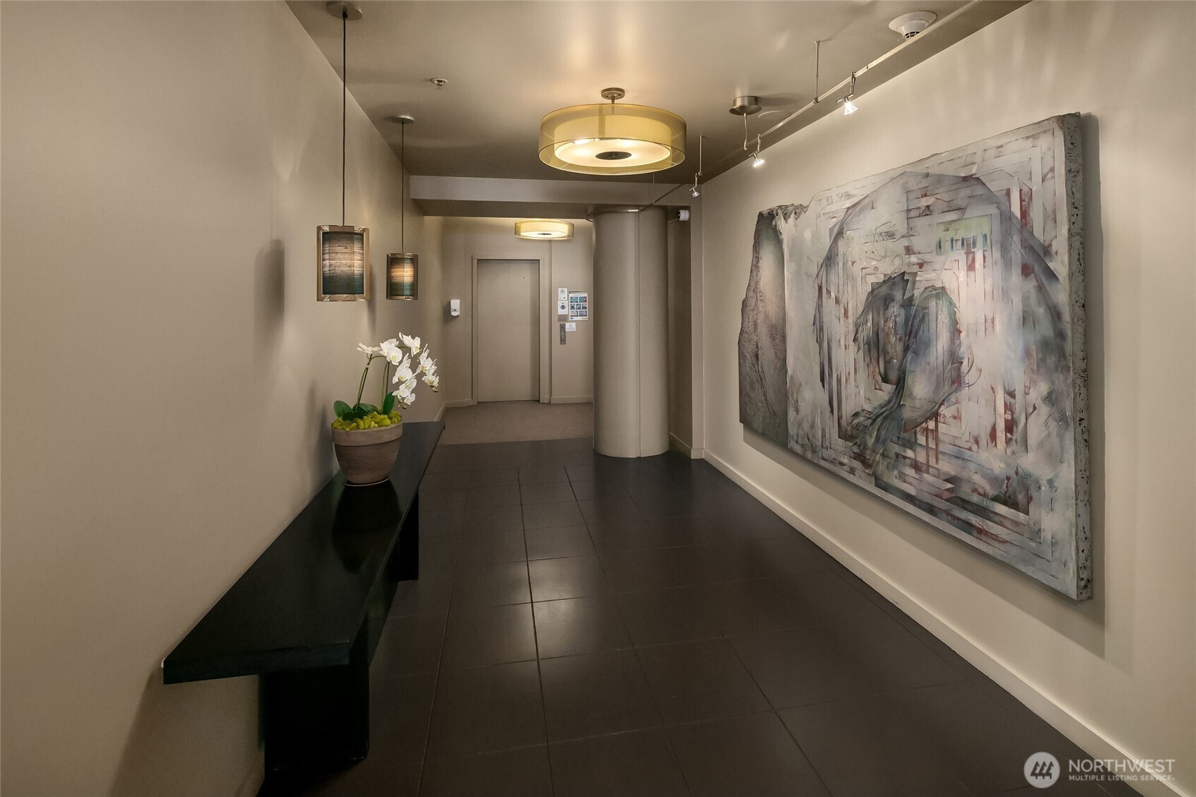 100 1st Avenue South, Unit 8 Seattle, WA 98104 - Photo 20 of 29 a view of a hallway with wooden floor and a chandelier