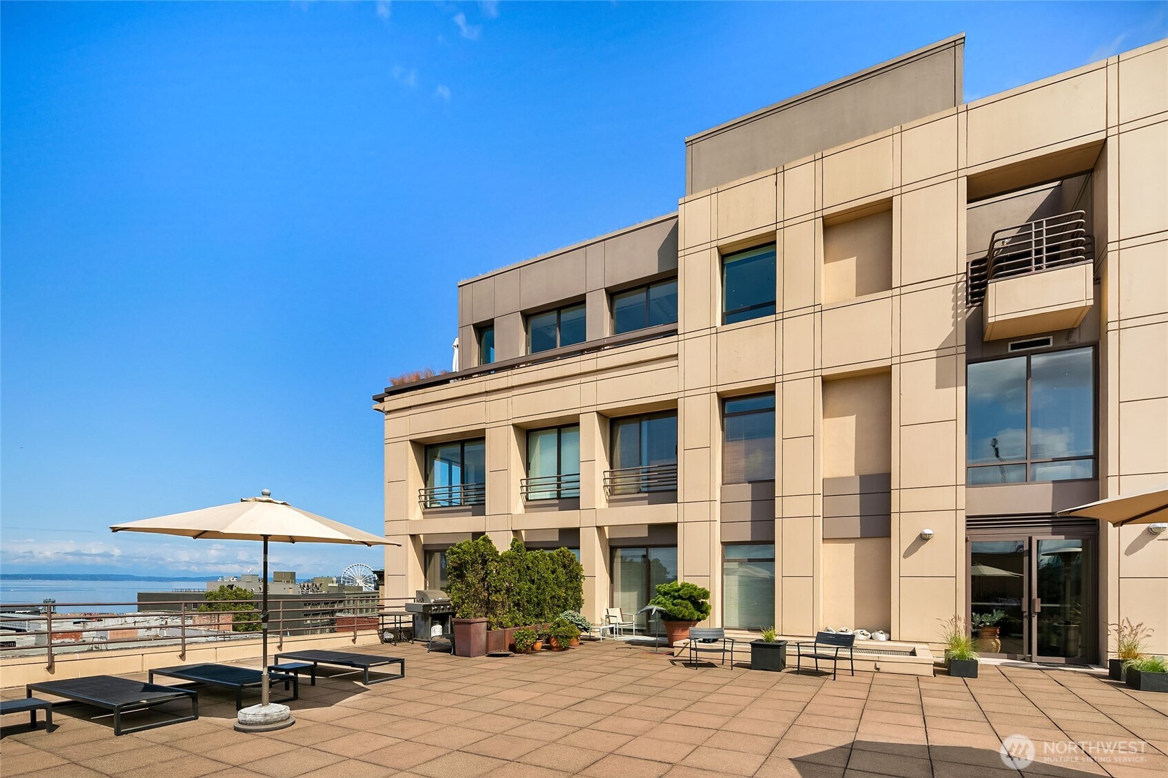 100 1st Avenue South, Unit 8 Seattle, WA 98104 - Photo 2 of 29 a patio with a table and chairs under an umbrella