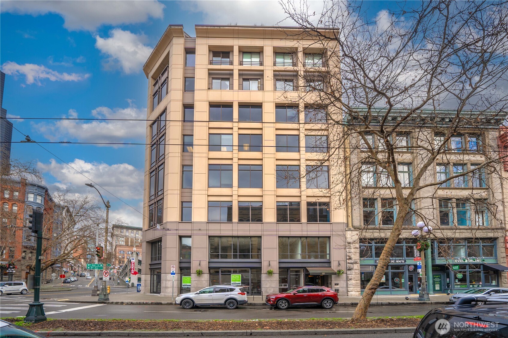 100 1st Avenue South, Unit 8 Seattle, WA 98104 - Photo 9 of 29 a front view of a building with lot of cars and trees
