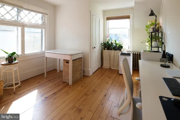 a view of a workspace with furniture and a window