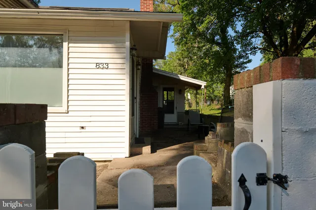 a view of a patio with couches chairs and a potted plant
