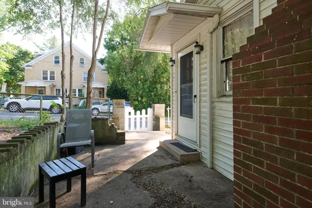 a view of a patio with table and chairs and potted plants