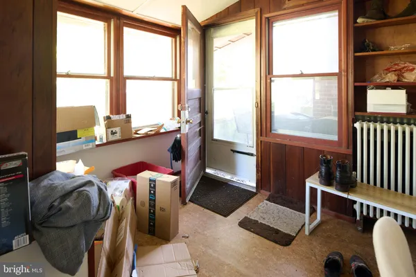 a dining room with furniture and a floor to ceiling window